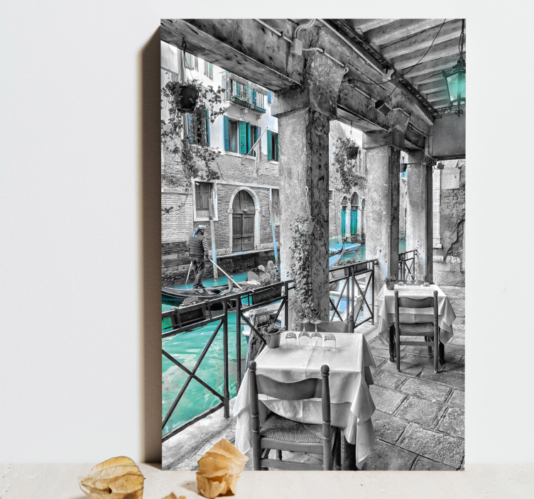 Leinwandbild Mann, der auf boot neben restaurant venedig reitet - TenStickers